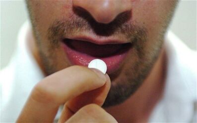 The man takes a pill to stimulate.
